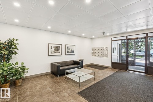 Tiled flooring with recessed lighting and a mailroom wall - #905 9929 113 St Nw, Edmonton, AB 