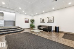 Recessed ceiling lighting illuminates the tiled flooring and white walls - 