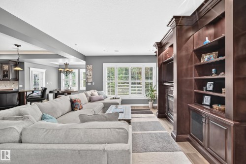 Built-in shelving with integrated cabinetry,recessed lighting, and white window shutters - 417 Caldwell Place Nw, Edmonton, AB 