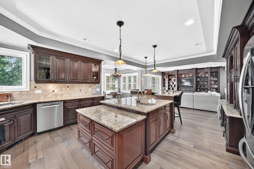 Kitchen featuring , recessed lighting, double island with undermount sink, and shaker-style cabinetry with glass accents - 417 Caldwell Place Nw, Edmonton, AB 