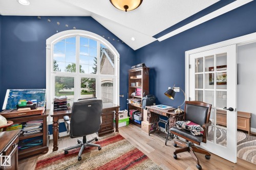 Arched picture window, vaulted ceiling,  recessed lighting, and French doors - 417 Caldwell Place Nw, Edmonton, AB 
