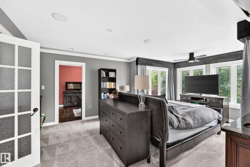 Ceiling fan, recessed lighting, French doors with frosted glass, large windows, and wall-to-wall carpeting - 417 Caldwell Place Nw, Edmonton, AB 