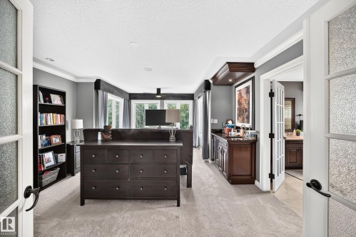 Light gray carpeting with crown molding and recessed lighting - 417 Caldwell Place Nw, Edmonton, AB 