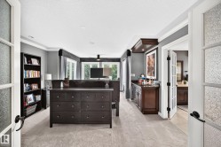 Light gray carpeting with crown molding and recessed lighting - 