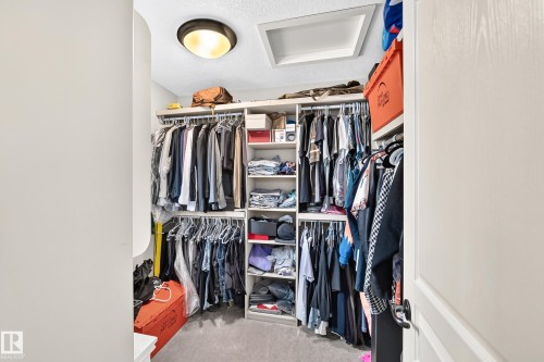 Built-in closet system featuring multiple hanging rods and shelving units - 417 Caldwell Place Nw, Edmonton, AB 