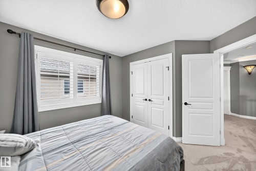 White interior window shutters, modern ceiling light fixture, white paneled doors, and gray wall paint - 417 Caldwell Place Nw, Edmonton, AB 