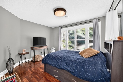 multiple windows with white plantation shutters, and a ceiling-mounted light fixture - 417 Caldwell Place Nw, Edmonton, AB 