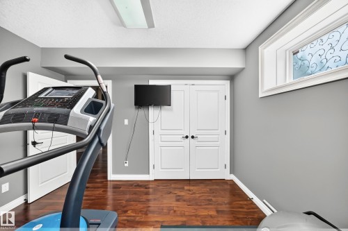 light gray walls, built-in dual panel doors, recessed lighting, and a frosted window with decorative detail - 417 Caldwell Place Nw, Edmonton, AB 