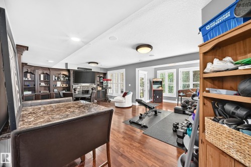 integrated built-in shelving, multiple windows with white plantation shutters, and recessed ceiling lighting - 417 Caldwell Place Nw, Edmonton, AB 