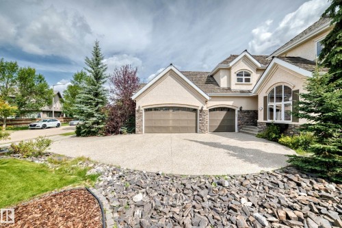 Stucco exterior with stone accents and multiple gables - 417 Caldwell Place Nw, Edmonton, AB 