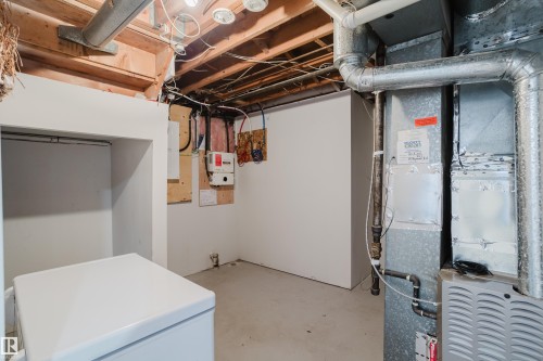 Unfinished basement area with exposed ceiling joists and utility hookups - 4708 106 Avenue Nw, Edmonton, AB 
