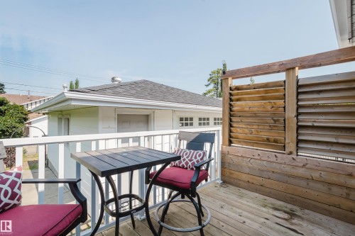 Deck with wood plank flooring and a slatted wood privacy wall - 4708 106 Avenue Nw, Edmonton, AB 