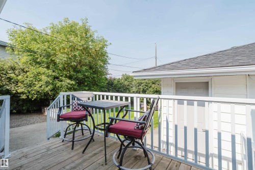 Wood-finish deck with white railings and an outdoor stairwell - 4708 106 Avenue Nw, Edmonton, AB 