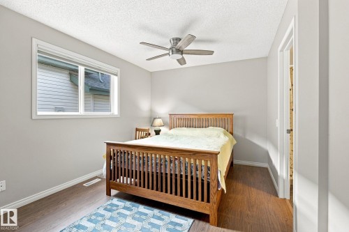 Wood-finish flooring, white trim, a ceiling fan, and a single window - 30 Belfry Fairway Crescent, Stony Plain, AB 