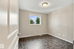 Neutral wall paint, patterned floor tiles, white trim, single window, and flush mount ceiling light - 