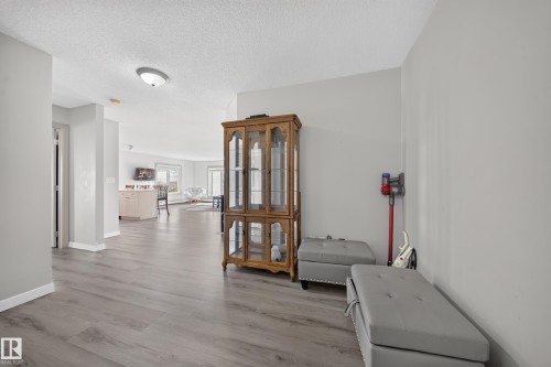 Wood-finish flooring throughout, light gray wall color, and recessed ceiling lighting - #419 4407 23 St Nw, Edmonton, AB 