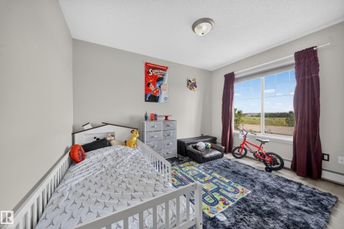 Large window with expansive outdoor scenery, neutral wall paint, and wood-finish flooring - #419 4407 23 St Nw, Edmonton, AB 