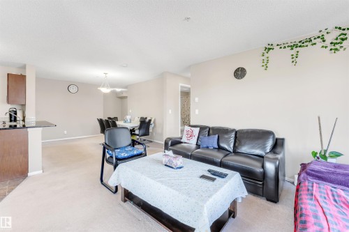 Open-concept living space with carpeted flooring - #225 111 Watt Cm Sw, Edmonton, AB 