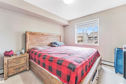 Carpeted flooring, recessed ceiling, window with white trim - #225 111 Watt Cm Sw, Edmonton, AB 