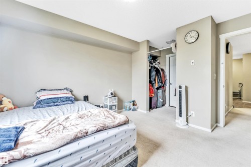 Recessed wall niche, built-in closet with hanging rod, light neutral wall paint, and light neutral carpeting - #225 111 Watt Cm Sw, Edmonton, AB 