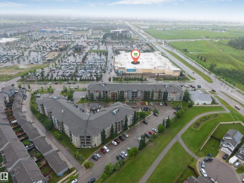 Mid-rise residential buildings with surrounding surface parking, adjacent to commercial retail developments and established roadways - #225 111 Watt Cm Sw, Edmonton, AB 