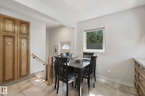 Built-in cabinetry, ceramic tile flooring, and a large window providing natural illumination - 12916 63 Street Nw, Edmonton, AB 