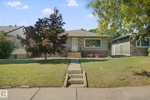 Single-story exterior with light-colored siding - 12916 63 Street Nw, Edmonton, AB 