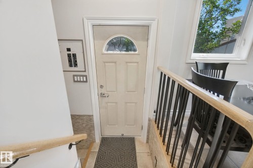 Entry door with an arched decorative glass insert and a security deadbolt - 12916 63 Street Nw, Edmonton, AB 
