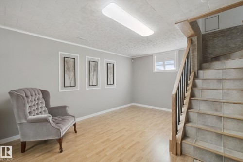 Recessed lighting illuminates wood-finish flooring and light gray walls - 12916 63 Street Nw, Edmonton, AB 