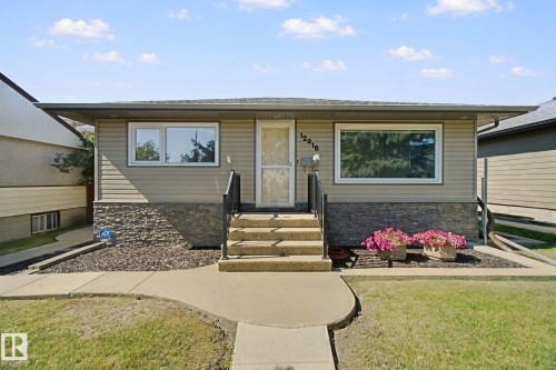 Horizontal siding exterior with stone accent detailing - 12916 63 Street Nw, Edmonton, AB 