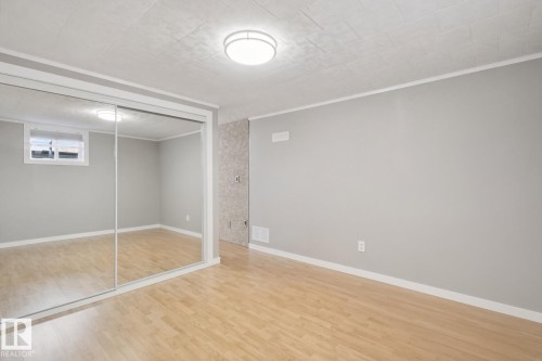 Wood-finish flooring, mirrored sliding doors, recessed window, flush-mount ceiling light - 12916 63 Street Nw, Edmonton, AB 