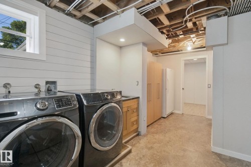 Utility space featuring a window, shiplap wall, built-in cabinetry, and recessed lighting - 12916 63 Street Nw, Edmonton, AB 
