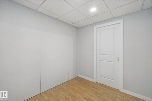 Recessed lighting, wood-finish flooring, drop ceiling, white two-panel door, and white trim - 12916 63 Street Nw, Edmonton, AB 