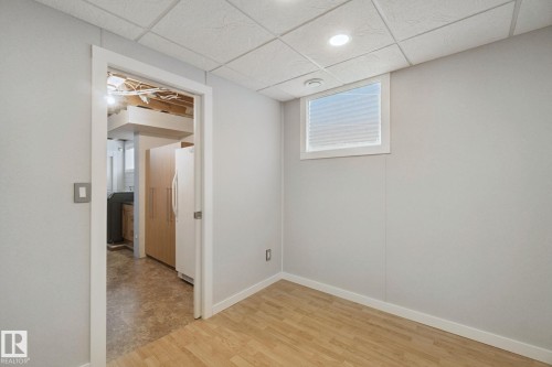 Wood-finish flooring, recessed ceiling lighting, and a window with blinds - 12916 63 Street Nw, Edmonton, AB 