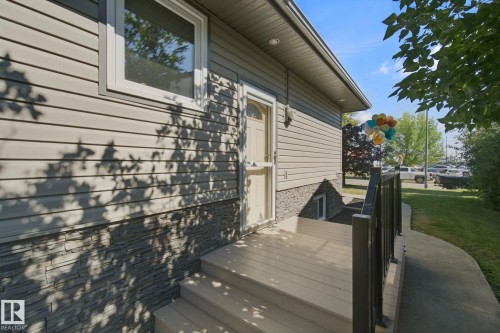 Exterior siding with a stacked stone veneer accent - 12916 63 Street Nw, Edmonton, AB 