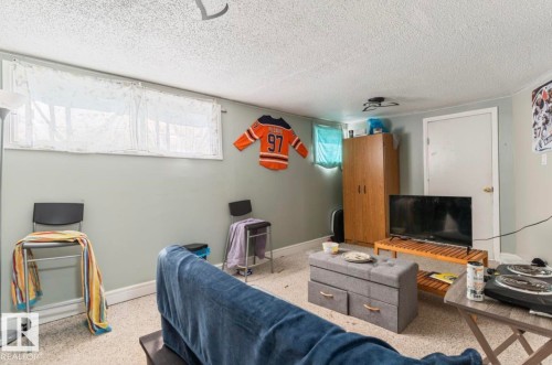 Recessed windows with privacy curtains, light gray walls, and textured ceiling finish - 12150 47 Street Nw, Edmonton, AB - Indoor