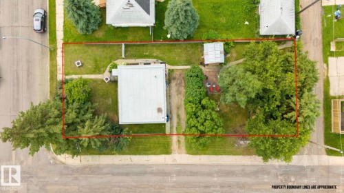 Expansive corner lot featuring a detached residence, mature trees, and a separate outbuilding - 12150 47 Street Nw, Edmonton, AB - Outdoor