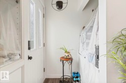 White entry door with decorative glass inserts and dark hardware - 
