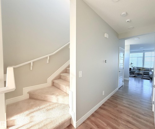 Carpeted staircase with white handrail and trim - 1003 Goldfinch Way Nw, Edmonton, AB 