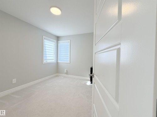 Plush carpet flooring, neutral painted walls, recessed ceiling lighting, and multi-pane windows - 1003 Goldfinch Way Nw, Edmonton, AB 