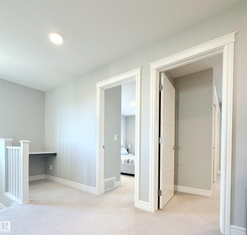 Upper level hallway with neutral wall paint, recessed lighting, and carpeted flooring - 1003 Goldfinch Way Nw, Edmonton, AB 