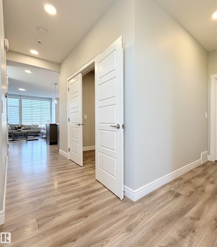 Recessed lighting, wood-finish flooring, light grey wall paint, white trim, and white paneled doors - 1003 Goldfinch Way Nw, Edmonton, AB 