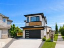 Contemporary two-story exterior with a flat roofline, featuring light-toned siding and stone accents - 16 Middleton Close, Leduc, AB  - Outdoor 