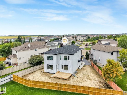 Light-colored siding exterior with a dark shingle roof - 16 Middleton Close, Leduc, AB 