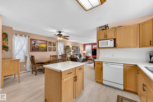 Kitchen featuring wood-finish cabinetry, white countertops, and wood-finish flooring - 1223 Gillespie Crescent Nw, Edmonton, AB 