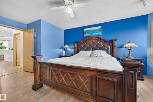 Wood-finish flooring, ceiling fan with integrated lighting, and a light wood-tone door - 1223 Gillespie Crescent Nw, Edmonton, AB 
