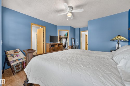 Wood-finish flooring with a white ceiling fan and light fixture - 1223 Gillespie Crescent Nw, Edmonton, AB 