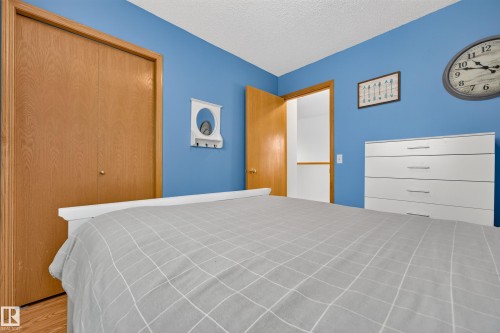 Wood-finish flooring, wood bi-fold closet doors, and a wood-frame doorway - 1223 Gillespie Crescent Nw, Edmonton, AB 