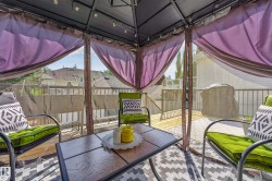 Expansive outdoor deck with wood-finish flooring and metal railings - 