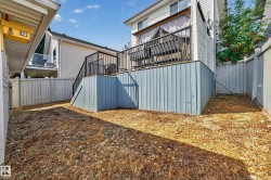 Raised outdoor deck with dark railing, blue-painted underdecking, and privacy curtains - 